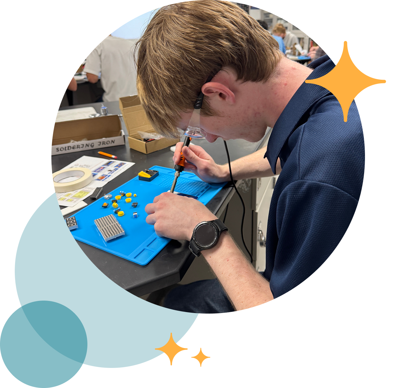 Close-up of a focused high school student soldering electronic components onto a circuit board in a hands-on manufacturing lab, surrounded by decorative star accents.