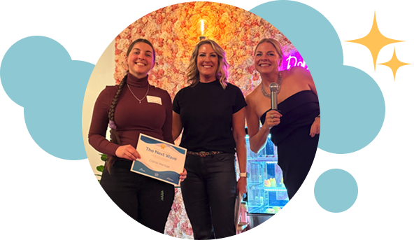 participants with arms around each other holding an award